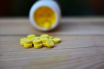 Obraz na płótnie Canvas Yellow pills placed on the table
