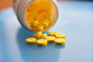 Yellow pills placed on the table