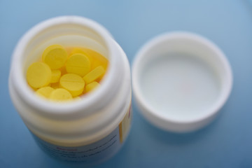 Yellow pills placed on the table