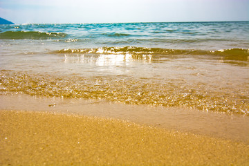 close up of waves crashing on to a beach