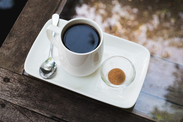 top view black coffee in the white cup on wooden table.