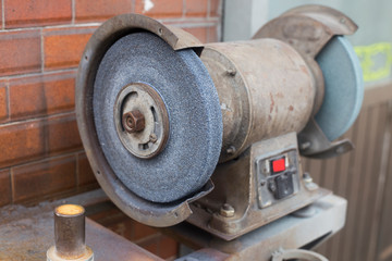 Old grinding machine. gray stone grinding wheel