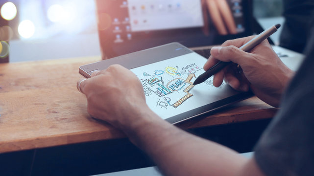 Businessman drawing and writing marketing plan on digital computer. Planning. Digital marketing and strategy business concept.