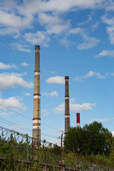 factory chimneys on background of blue sky