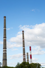 Fototapeta na wymiar factory chimneys on background of blue sky