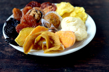 Mixed dried fruits on a cramped wooden table