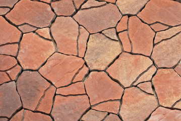 Cobblestone texture. The sidewalk tile is evenly folded. Different sizes and colors of paving stones.