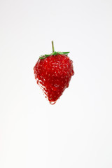 Strawberry with water drops on white background.