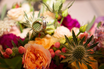 close up view of wedding rings in bridal bouquet