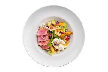 Grilled tuna with potato, cabbage, green beans and poached egg isolated on white