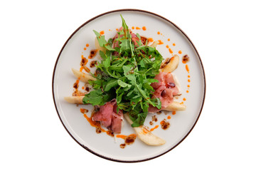 Salad with jamon, pear and arugula isolated on white