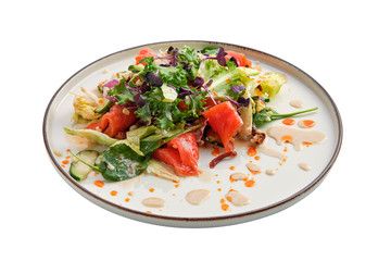 Salad with smoked salmon and fresh vegetables isolated on white