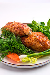 Stuffed chicken thigh decorated with spring onion, carrot, basil and dill