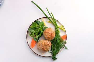 Fish cutlet served with fresh carrot, spring onion and parsey