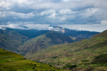 Obraz premium Mountain landscape cloudy sky green Alpine meadows in the mountains
