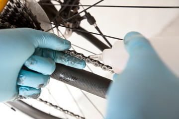 The mechanic is fixing the road bicycle in his workshop
