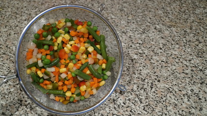 Mix of vegetables. Green asparagus beans, yellow corn, orange carrots, red pepper.