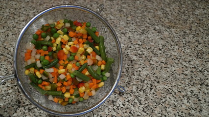 Mix of vegetables. Green asparagus beans, yellow corn, orange carrots, red pepper.