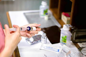 Nurses hands holding a syringe and vaccine bottle are preparing to injection drugs patient in a hospital.