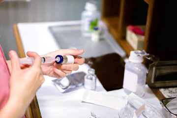 Nurses hands holding a syringe and vaccine bottle are preparing to injection drugs patient in a hospital.