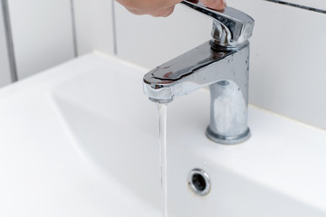 Close-up. Washing hands in the bathroom in the sink. Women's hands close the tap with water