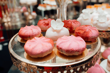 Cakes and berries in the candy bar. Candy Bar. Delicious sweet buffet with cupcakes. Sweet holiday buffet with cupcakes and other desserts.