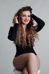 Fototapeta premium Healthy hair. Beautiful young sexy woman with long curly hairstyle. Brunette with professional makeup.