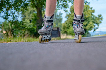 roller skates in action on the asphalt trail at freestyle races outside the city