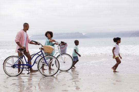 Family walking with bicycle on a sunny day