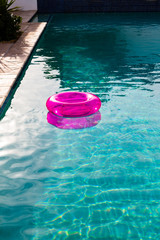 Inflatable tube floating in a swimming pool in backyard