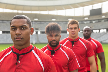 Male rugby players standing together in stadium