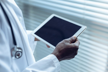 Male doctor using digital tablet in hospital