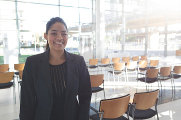 Smiling businesswoman standing in conference room 