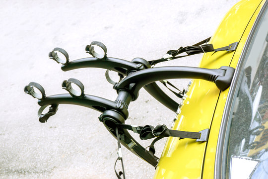 Bicycle Car Holder Installation Is Available On A Yellow Car Trunk.