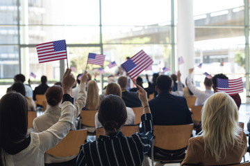 Businessman doing speech and celebrating victory in conference room