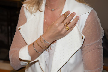 close up of beautiful woman with ring and bracelet in hand arm