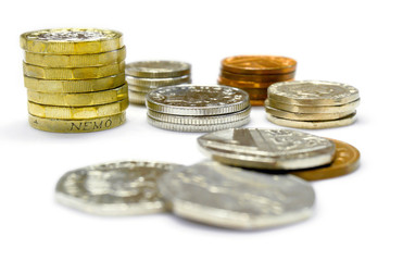 The new one pound as vertical and stack of British currency coins isolate on white background.