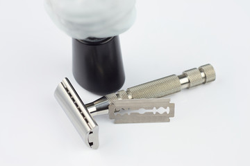 safety razor with foam brush and razor blade.