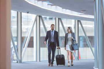 Business people walking together in the corridor at modern office building
