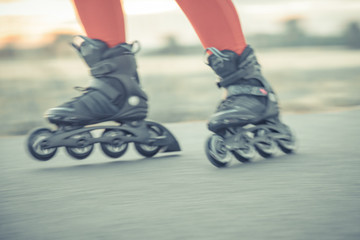 roller skates in action on the asphalt trail at freestyle races outside the city