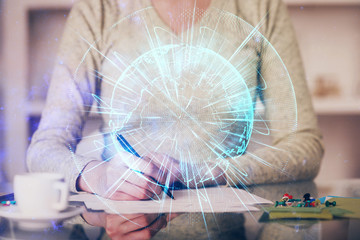 International business hologram over woman's hands taking notes background. Concept of success. Double exposure