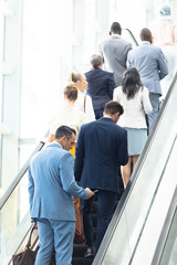 Diverse business people on escalator 