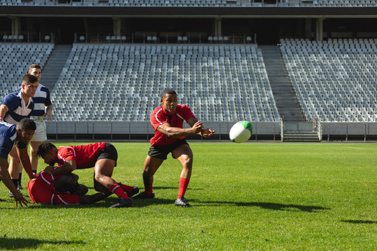 Male rugby players playing rugby match in stadium