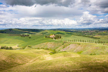 A farmhouse between Tuscan hills. Pienza, Val d'Orcia, Tuscany, Italy.