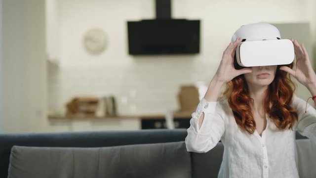 Boring woman in vr glasses. Smiling girl playing 3d interactivity