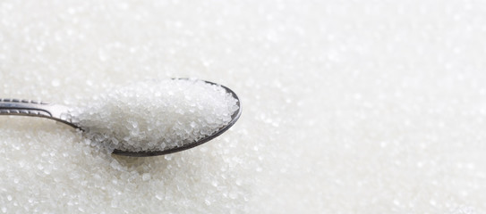 Spoon with white sugar banner background