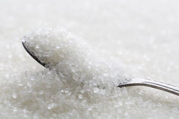 Closeup of spoon with white sugar
