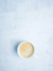 Obraz na płótnie Canvas Coffe cup on light blue background. Copy space. Flat lay. 