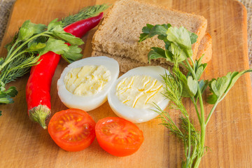 boiled egg, tomato, pepper on cutting board
