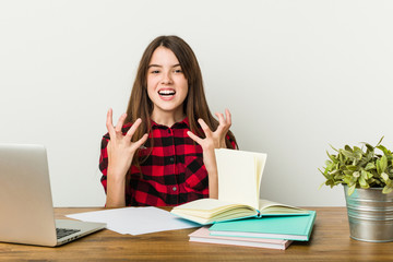 Young teenager going back to her routine doing homeworks upset screaming with tense hands.